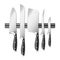 Kitchen knives hanging on magnetic holder set, butcher equipment and cooking tool.