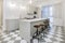 Kitchen with marble top and island with wood and metal stools