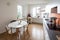 Kitchen with orange tiles and a modern table. Large window with a view