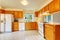 Kitchen room with maple cabinets and white appliances