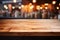 Kitchen space with kitchen utensils in blur and wooden table in foreground. Essence of warm and functional kitchen