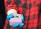 Kitchen sponge with a drop of cleaning agent. Hands of a girl in a hygienic glove