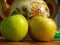 Kitchen still life. Ripe apples next to the old ceramic teapot.