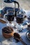 Kitchen still life with whole coffee beans, ground coffee, coffee grinder, glass mugs filled with black coffee,