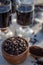 Kitchen still life with whole coffee beans, ground coffee, coffee grinder, glass mugs filled with black coffee,