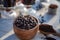 Kitchen still life with whole coffee beans, ground coffee, coffee grinder, glass mugs filled with black coffee,