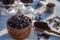 Kitchen still life with whole coffee beans, ground coffee, coffee grinder, glass mugs filled with black coffee,