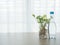 Kitchen table with bottle of water and betel tree on glass vase