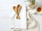 On the kitchen table kitchen utensils on a kitchen towel on a white background