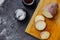 Kitchen table with spices for cooking homemade yam food.salt, paprika and round slices of raw red sweet potato on wooden desk,