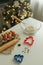 On the kitchen table there is a bowl with flour, a whisk, spices and molds for making Christmas cookies