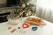 On the kitchen table there is a bowl with flour, a whisk, spices and molds for making Christmas cookies