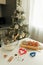 On the kitchen table there is a bowl with flour, a whisk, spices and molds for making Christmas cookies