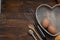 Kitchen Tools for Bakerry or cooking. Raw Eggs with wooden spooon, Orange Napkin, Heart Shape Box and Baking tools. Copy Space. Fl