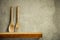 Kitchen tools on wooden shelf. Copy empty space for your decoration and products. Beige brown retro wall background.