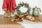 Kitchen utensils. Christmas wreath, teapot, chicken eggs, champagne glasses, wooden rolling pins on a wooden cabinet
