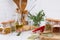 Kitchen utensils, herbs, colorful dry spices in glass jars on white table