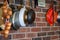 Kitchen utensils and pans hanging on a red brick wall. Onions and kitchen scales