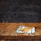 Kitchen utensils on tablecloth on wooden textures table against chalkboard background