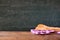 Kitchen utensils on tablecloth on wooden textures table against chalkboard background