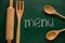 Kitchen utensils and text MENU written on chalkboard, top view