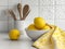 Kitchen utensils on white table with yellow kitchen towel