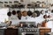 kitchen, with vintage pots and pans hanging above a modern stove