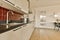 a kitchen with white cabinets and a black counter top