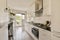 a kitchen with white cabinets and a black counter top