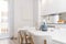 Kitchen with white cabinets with wooden tops, mirrored wall, stoneware