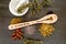 Kitchen Witch - spoon with dried Herbs on gray / grey slate background - chamomile, hibiscus, arnica,  elder flower, rose bud and