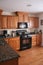 Kitchen wood cabinets black stove