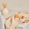 Kitchen wooden dishwashing brush and natural muslin towel. Stylish composition made from natural materials.