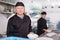 Kitchen worker arranging cleaned dishes