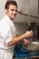 Kitchen Worker Washing Up In Restaurant Kitchen