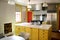 Kitchen yellow wood cabinets stainless stove