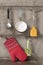 Kitchenware hanging on stainless rail on cement wall background