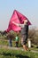 Kite festival - a man holding pink triangle kite