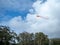 Kite flying high in the sky with parting clouds