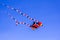 The Kite Full of Color Flying Against a Blue Sky.