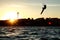 Kite sportsman jumping with splash of water, crystal sky, kiteboarding water sports, active life style. Kiteboarding big air frees