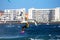 Kite surfer in front of apartment buildings of a popular resort town on Tenerife island