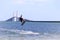 Kite surfer gaining air with a kite above as he attempts to jump the skyway bridge