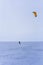 Kite surfer ride on snowboard. Snowkiting in the snow on frozen lake