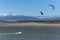 Kite surfers at the Alvor estuary near the town of Alvor, in Algarve, Portugal, with the Monchique mountain on the background