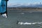 Kite surfers at the Alvor estuary near the town of Alvor, in Algarve, Portugal, with the Monchique mountain on the background