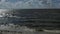 Kite surfing on the sea. Slow panning panorama shot.