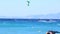Kite surfing - surfers on blue sea surface