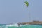 Kiteboarder jumping in waves off Estoril beach Cape Verde