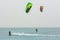 Kiteboarder and kite hydrofoiling man